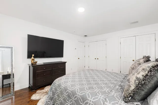 a bedroom with a bed and a flat screen tv