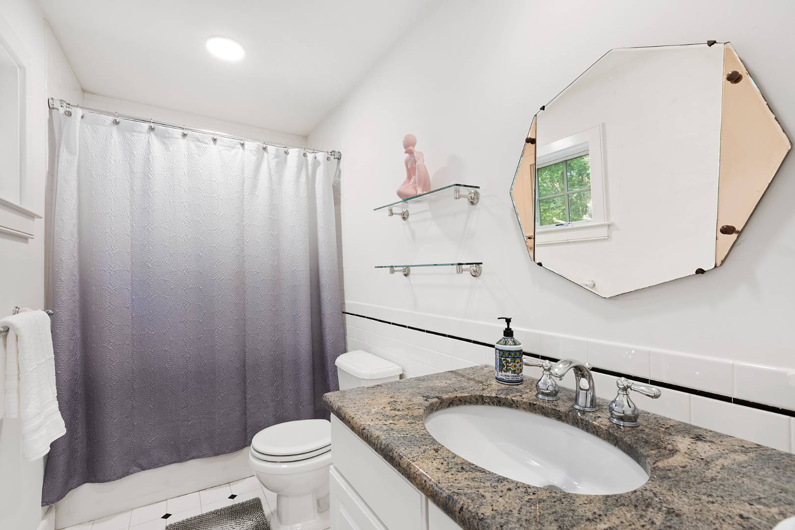 25 Old Sag Harbor Road Bridgehampton, NY 11963 - Photo 15 of 19 a bathroom with a granite countertop sink a toilet and a mirror