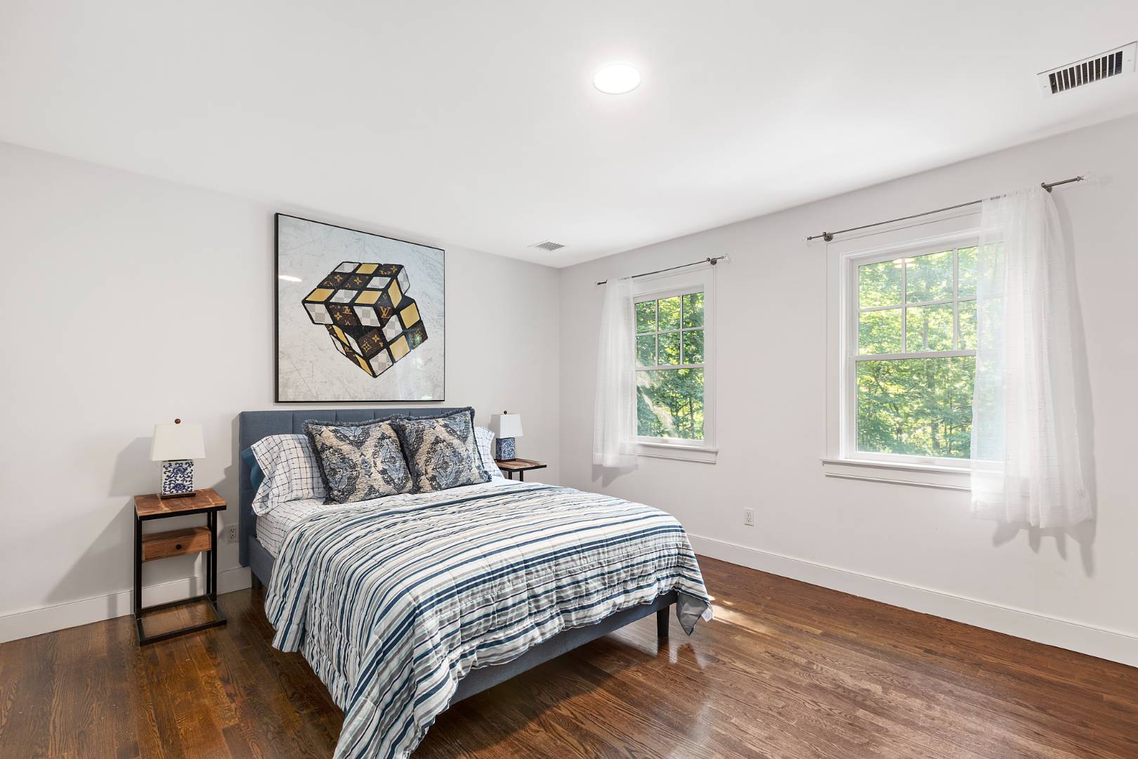 25 Old Sag Harbor Road Bridgehampton, NY 11963 - Photo 16 of 19 a bedroom with a bed and a painting on the wall