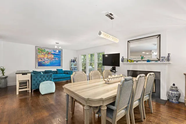 a dining room with furniture and wooden floor