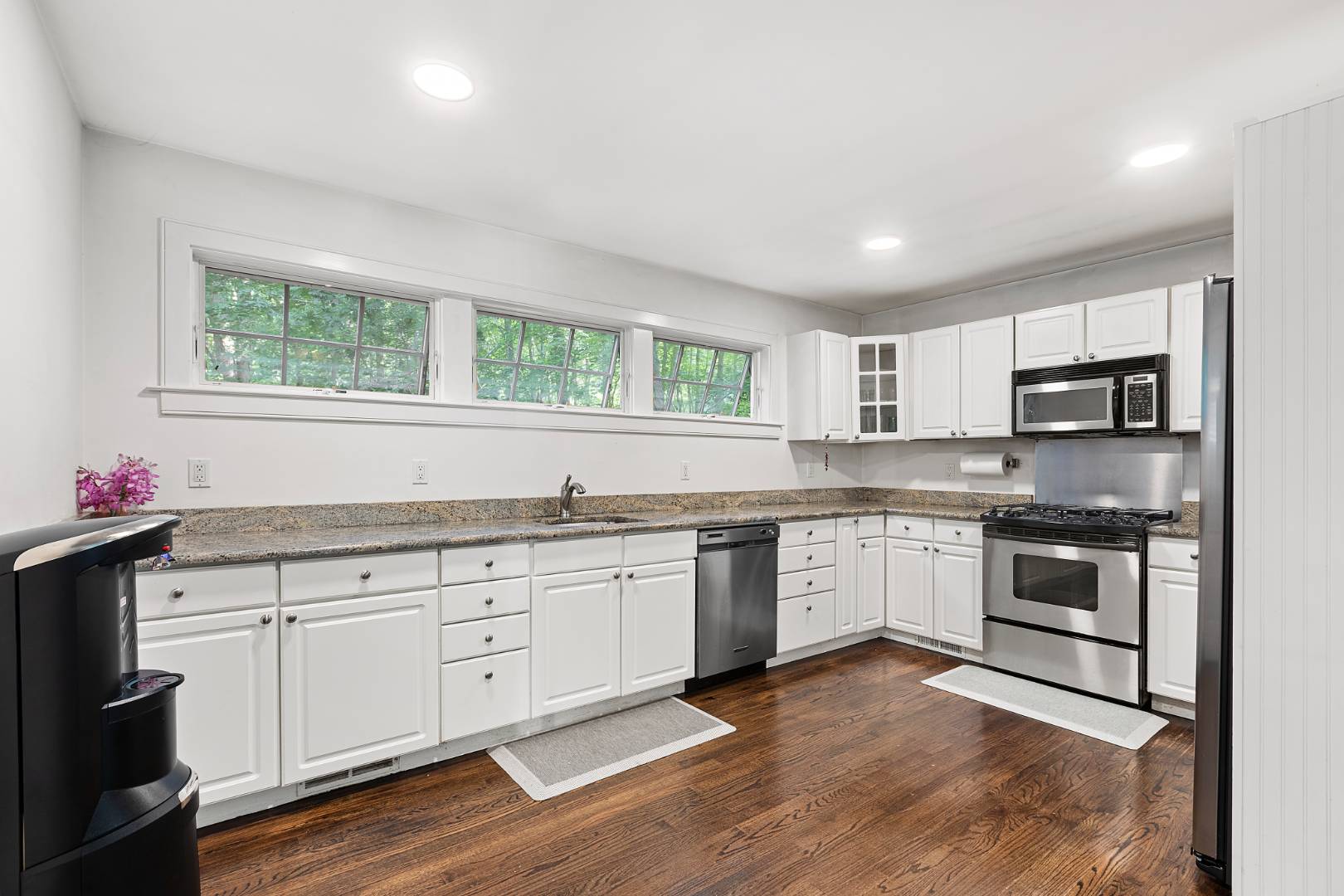 25 Old Sag Harbor Road Bridgehampton, NY 11963 - Photo 10 of 19 a kitchen with granite countertop cabinets stainless steel appliances a sink and a window