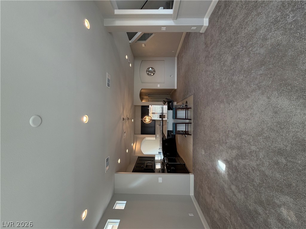 6385 Jackson Spring Road Las Vegas, NV 89118 - Photo 4 of 36 An open-concept living space with high ceilings and recessed lighting flows into a well-appointed kitchen.