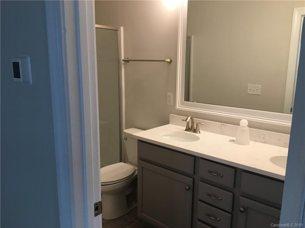 17535 Shearer Road Davidson, NC 28036 - Photo 11 of 22 a bathroom with a granite countertop sink toilet and shower