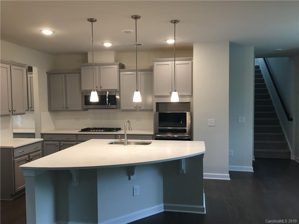 17535 Shearer Road Davidson, NC 28036 - Photo 6 of 22 a kitchen with kitchen island a sink appliances and cabinets