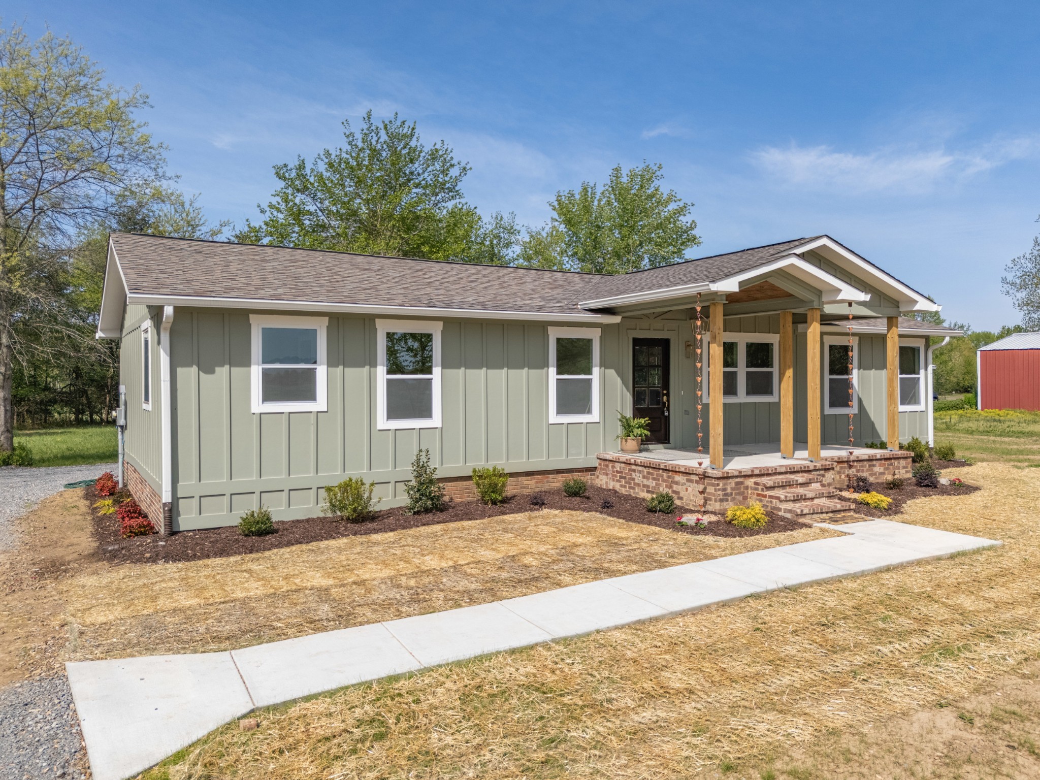 259 Patrick Road Fayetteville, TN 37334 - Photo 1 of 34 a front view of a house with a garden and yard