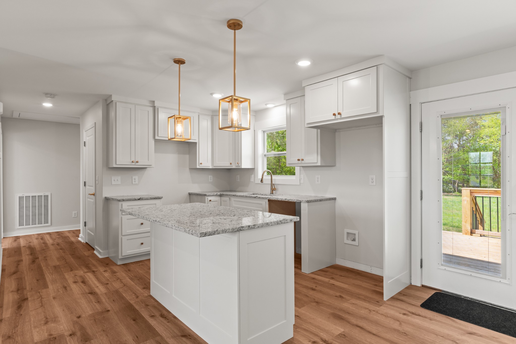 259 Patrick Road Fayetteville, TN 37334 - Photo 8 of 34 a kitchen with stainless steel appliances granite countertop a sink a stove a refrigerator and white cabinets with wooden floor