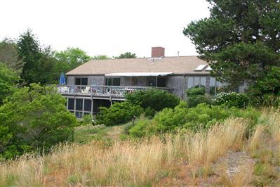 Undisclosed Address Orleans, MA 02653 - Photo 2 of 9 a house view with a garden space