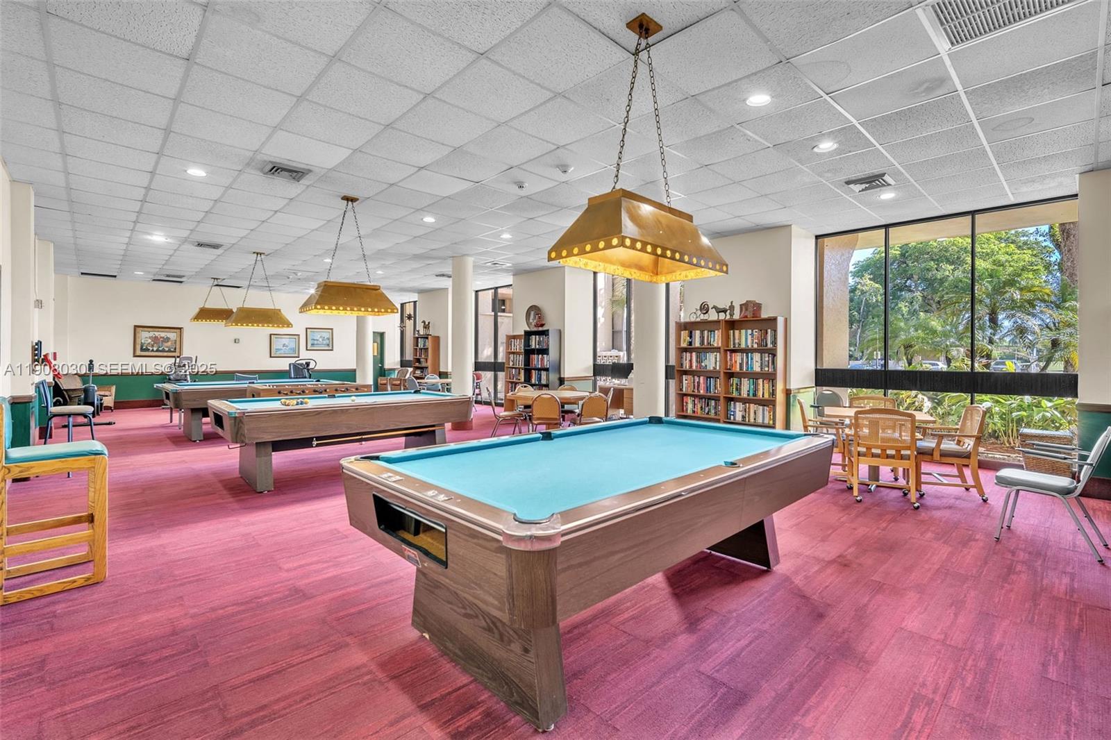 2810 North 46th Avenue, Unit F655 Hollywood, FL 33021 - Photo 13 of 52 a living room with furniture a table and chairs in it