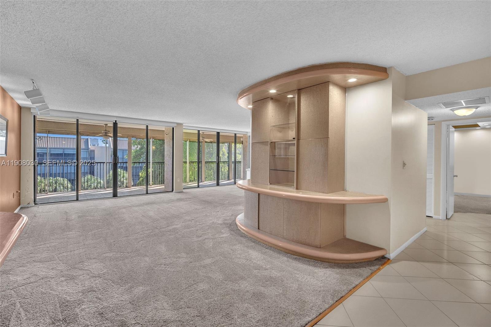 2810 North 46th Avenue, Unit F655 Hollywood, FL 33021 - Photo 15 of 52 a view of an empty room with a sliding door