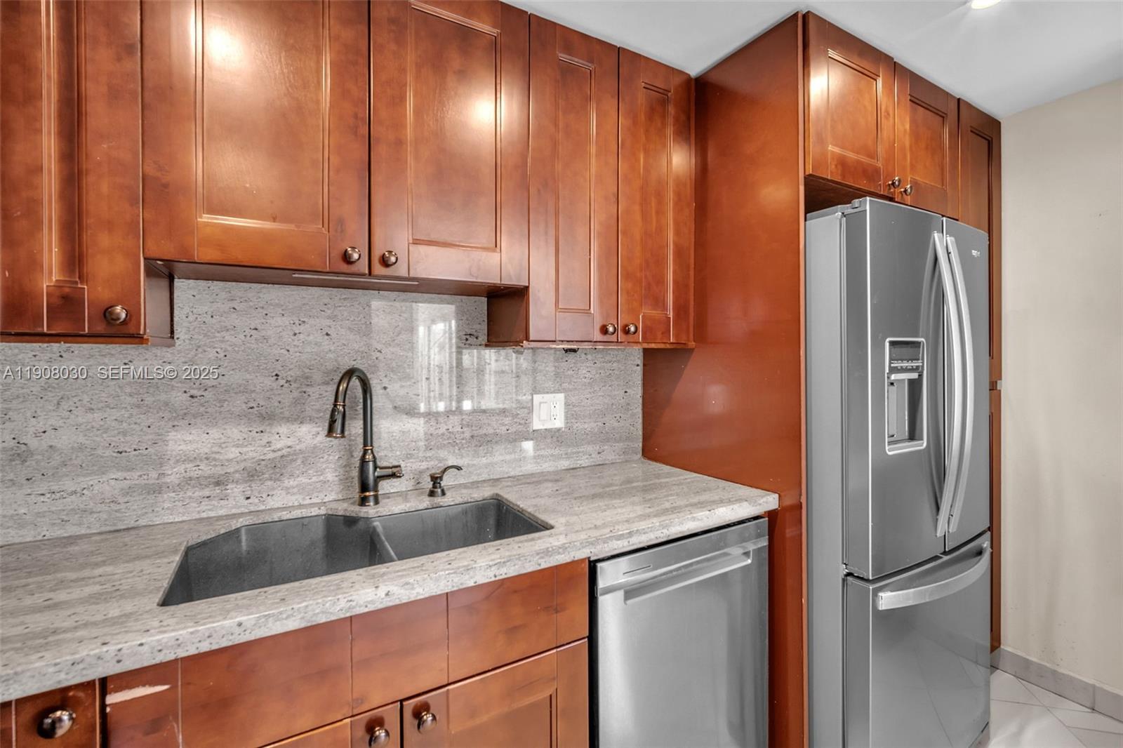 2810 North 46th Avenue, Unit F655 Hollywood, FL 33021 - Photo 25 of 52 a kitchen with stainless steel appliances granite countertop a sink a refrigerator and a granite counter tops