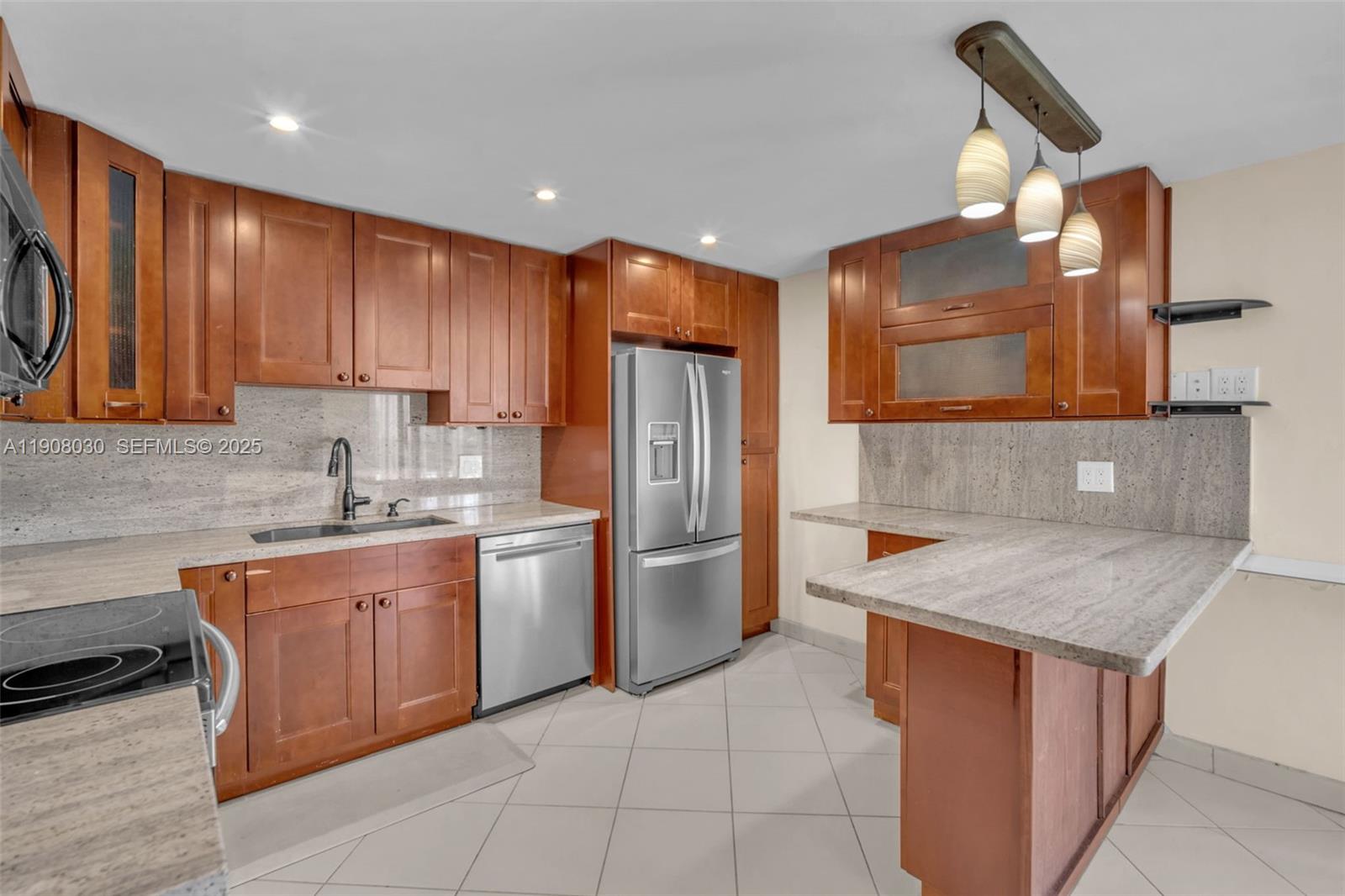2810 North 46th Avenue, Unit F655 Hollywood, FL 33021 - Photo 29 of 52 a kitchen with stainless steel appliances granite countertop wooden cabinets a sink and a stove