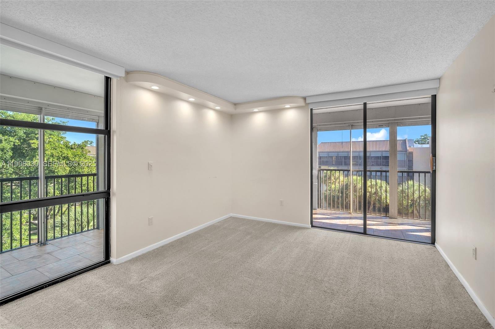 2810 North 46th Avenue, Unit F655 Hollywood, FL 33021 - Photo 32 of 52 a view of an empty room with wooden floor and a sliding door