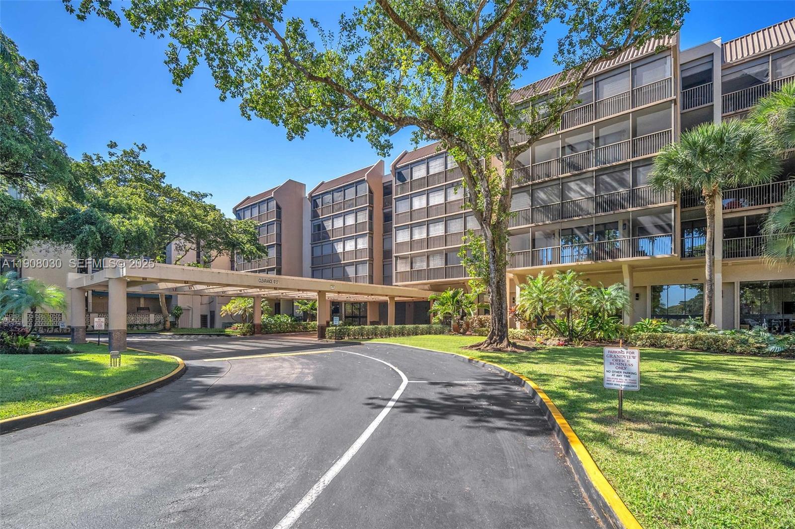2810 North 46th Avenue, Unit F655 Hollywood, FL 33021 - Photo 10 of 52 a front view of a building with a garden and trees