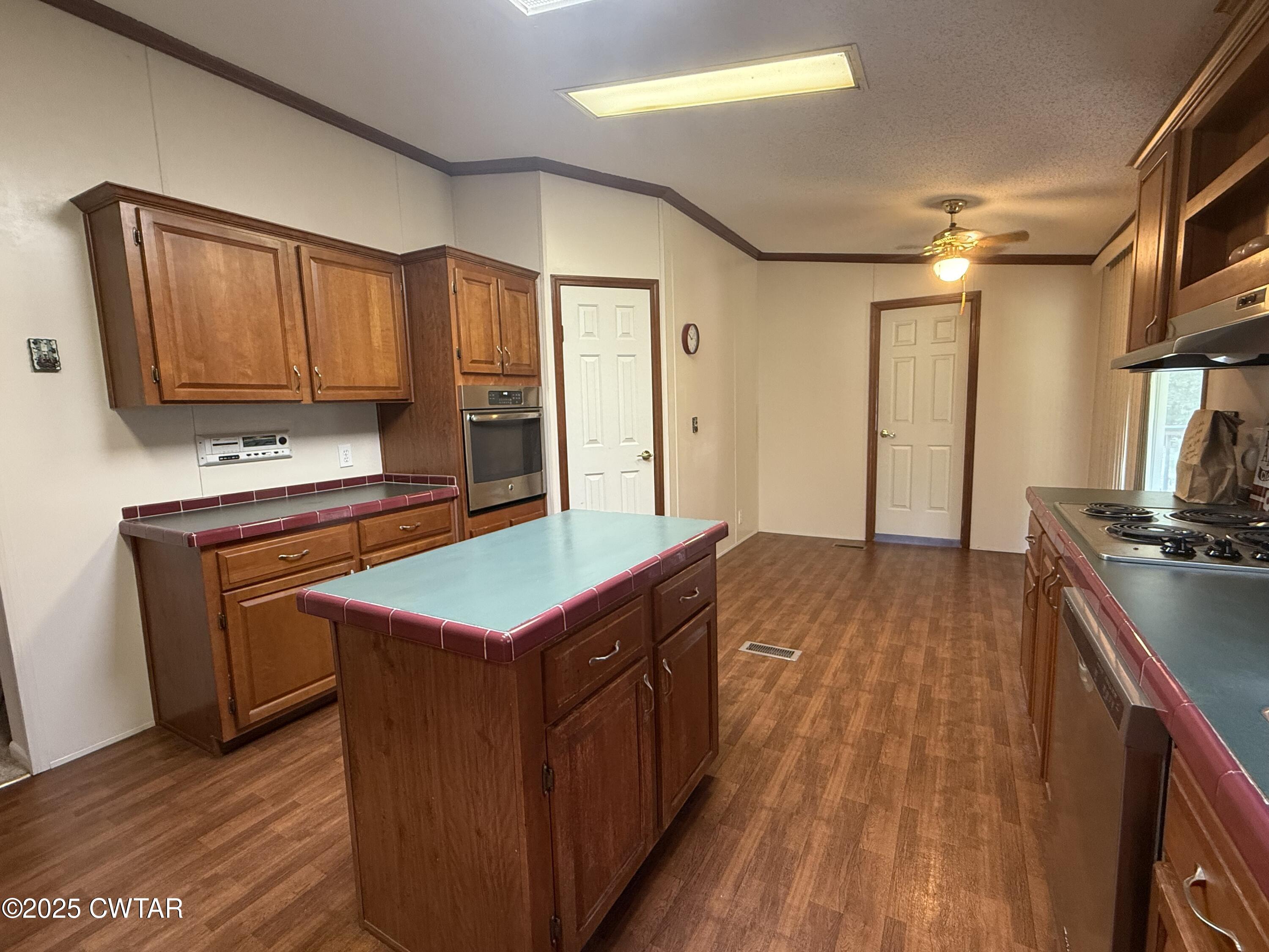 501 Post Office Road Michie, TN 38357 - Photo 11 of 20 a kitchen with kitchen island granite countertop wooden cabinets a sink and a stove