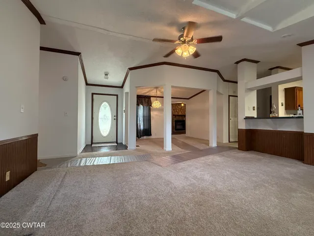 a view of an empty room with a kitchen