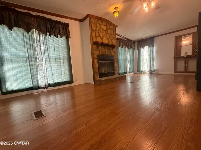 a view of a livingroom with wooden floor and a window