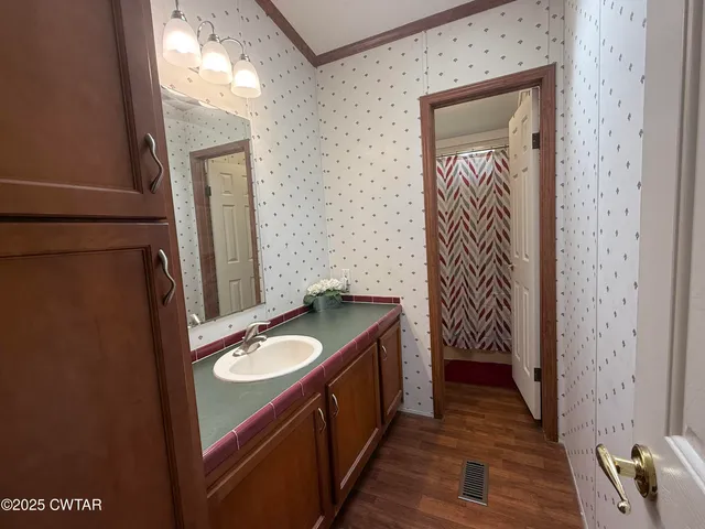 a bathroom with a granite countertop sink and a mirror