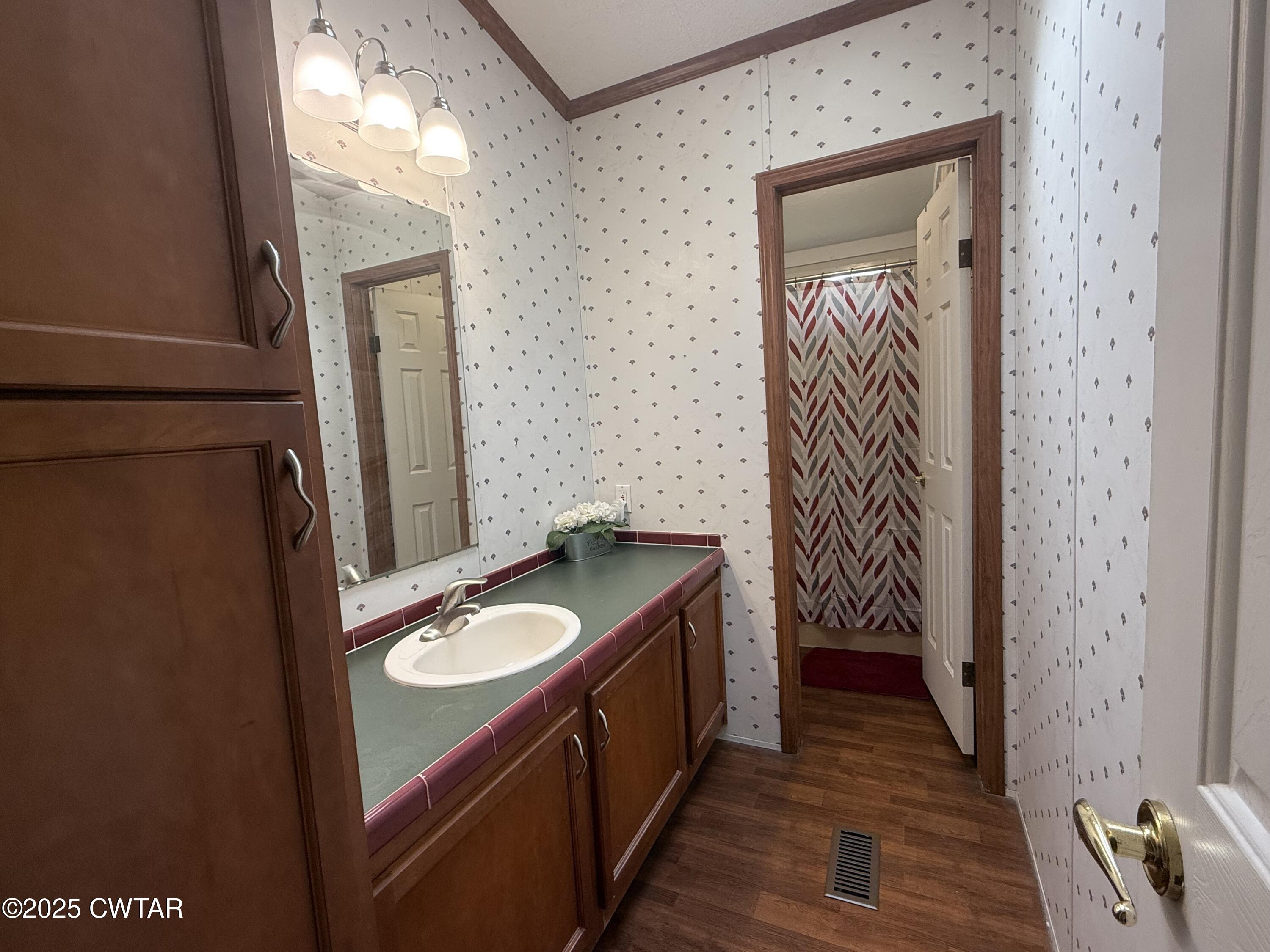 501 Post Office Road Michie, TN 38357 - Photo 19 of 20 a bathroom with a granite countertop sink and a mirror