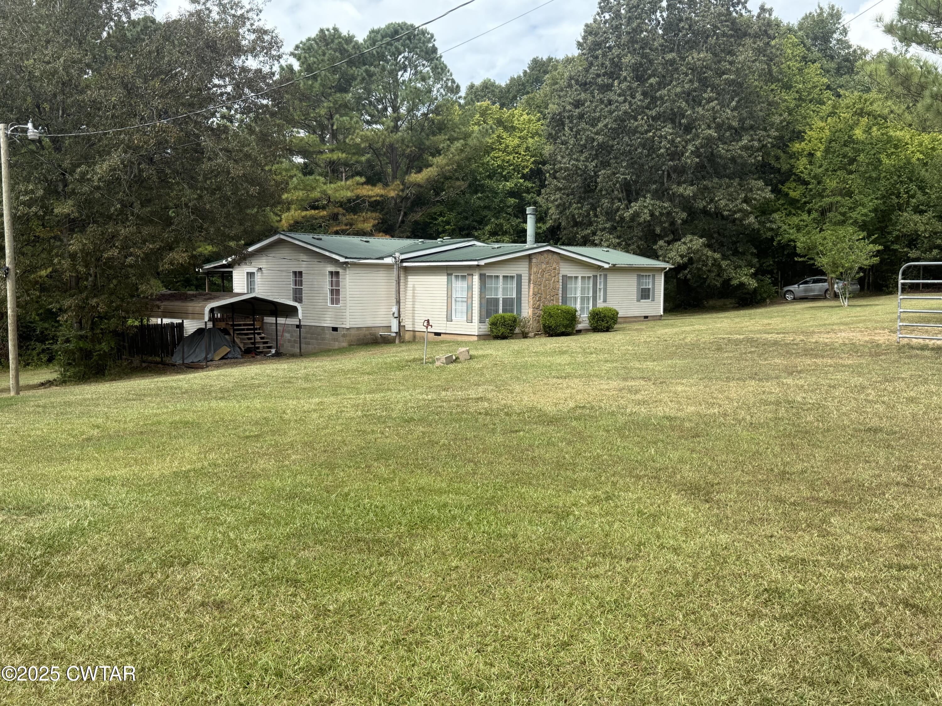 501 Post Office Road Michie, TN 38357 - Photo 4 of 20 a front view of a house with yard and green space