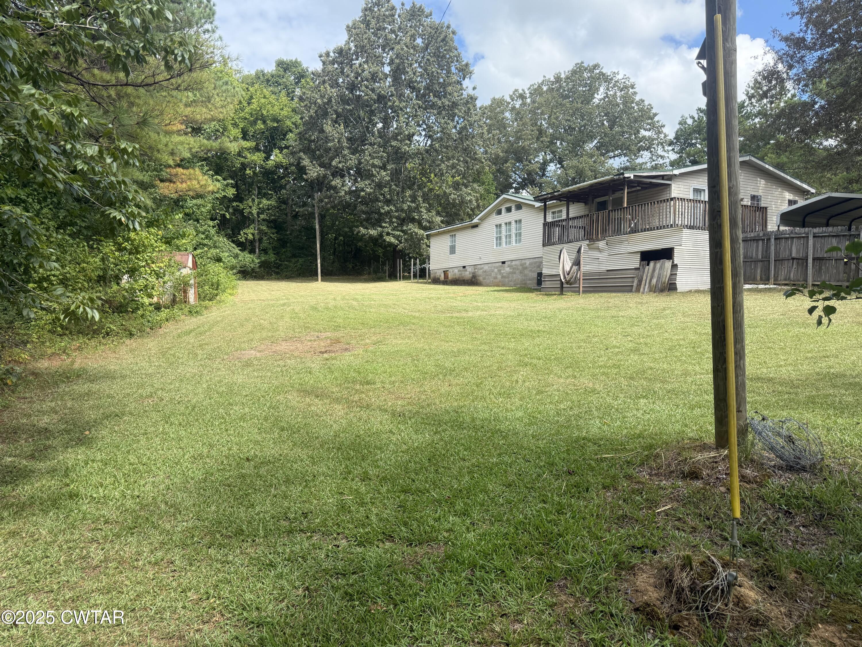 501 Post Office Road Michie, TN 38357 - Photo 7 of 20 a view of a house with backyard and a tree