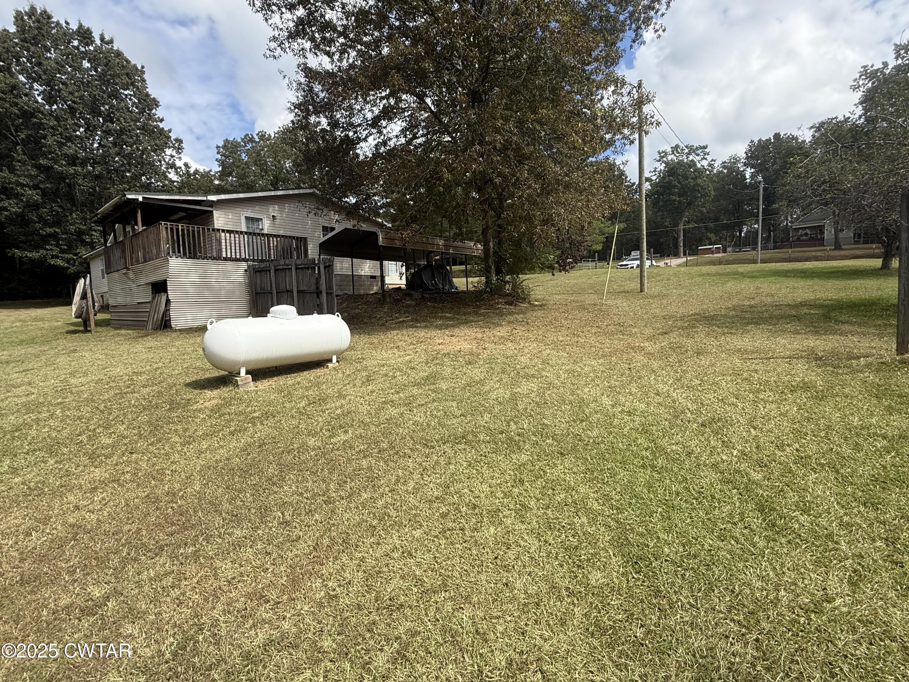 501 Post Office Road Michie, TN 38357 - Photo 8 of 20 a swimming pool with some trees in the background