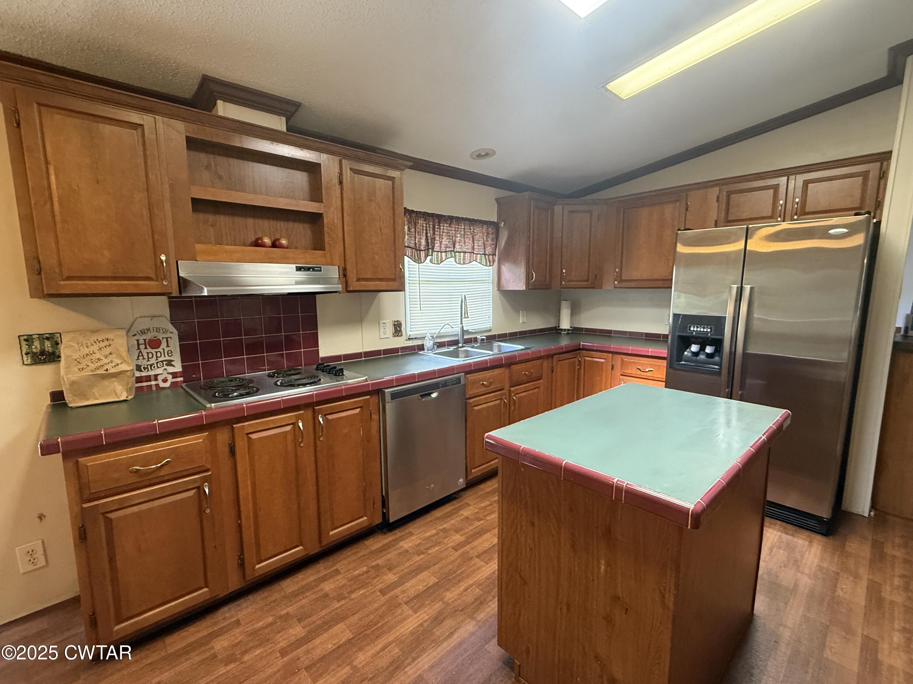 501 Post Office Road Michie, TN 38357 - Photo 9 of 20 a kitchen with stainless steel appliances granite countertop wooden cabinets a sink and a stove