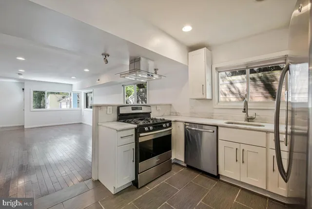 a kitchen with a stove top oven sink and cabinets