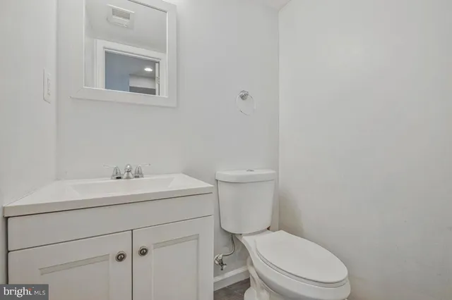 a white toilet sitting next to a bathroom sink