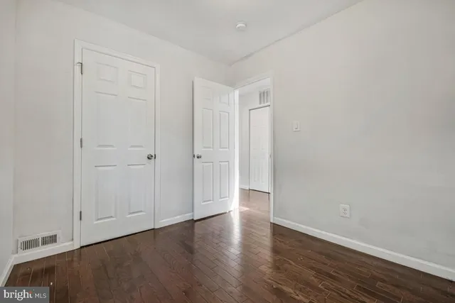 a view of an empty room and wooden floor