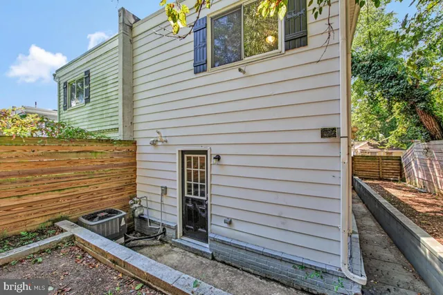a view of a backyard with chairs and a barbeque
