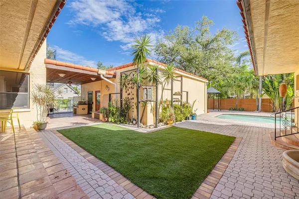 a view of a house with backyard and porch