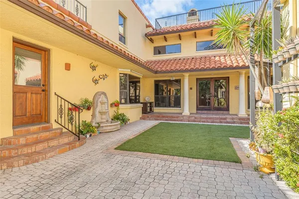 a spacious bedroom with a large bed and a chandelier