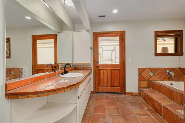a bathroom with a tub and shower