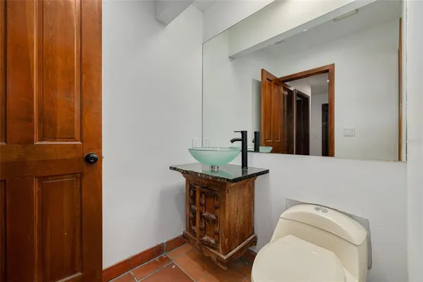 a view of an empty room with window and a chandelier fan