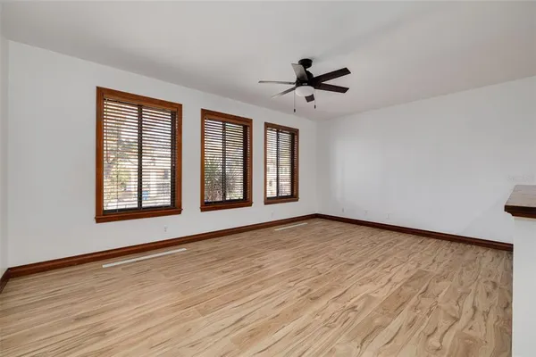 a view of a kitchen with a sink and wooden floor
