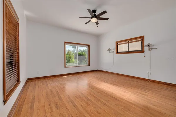 wooden floor in an empty room with a window