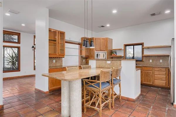 a kitchen with stainless steel appliances a stove sink and microwave