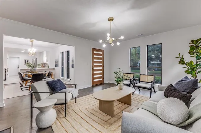 a living room with furniture and a chandelier
