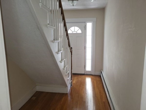 22 Pine Street Leicester, MA 01524 - Photo 11 of 13 a view of a hallway with wooden floor and stairs
