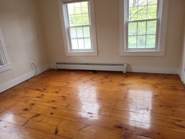 22 Pine Street Leicester, MA 01524 - Photo 12 of 13 an empty room with wooden floor and windows