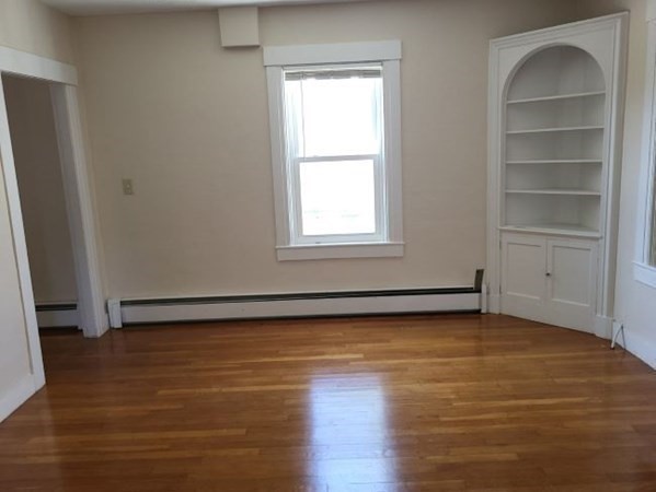 22 Pine Street Leicester, MA 01524 - Photo 7 of 13 a view of an empty room with wooden floor and a window
