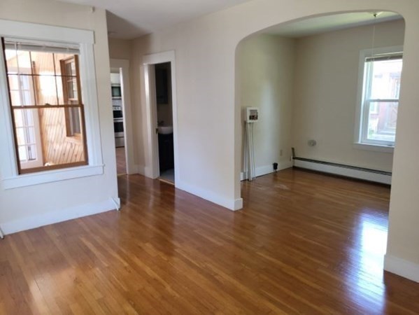 22 Pine Street Leicester, MA 01524 - Photo 8 of 13 an empty room with wooden floor and windows