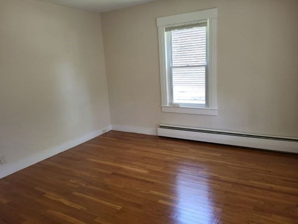 22 Pine Street Leicester, MA 01524 - Photo 10 of 13 a view of an empty room with wooden floor and a window