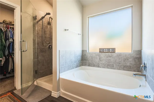 a bathroom with a bathtub and a shower