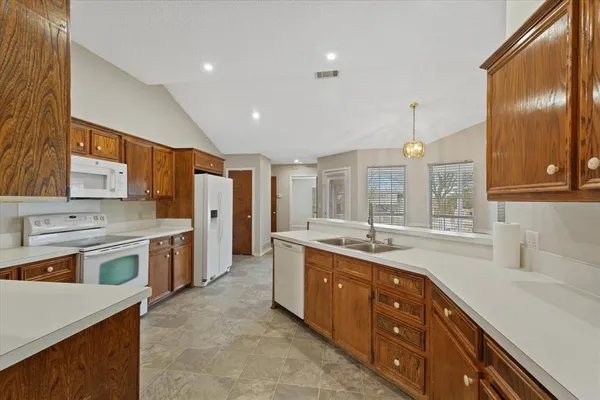 a kitchen with stainless steel appliances granite countertop a sink stove and cabinets