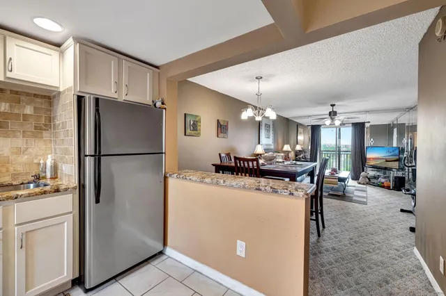 a kitchen with a refrigerator a stove and a sink