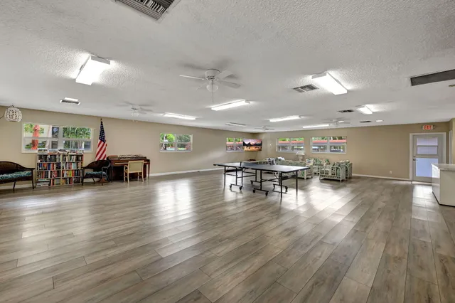 a room with lots of furniture and wooden floors