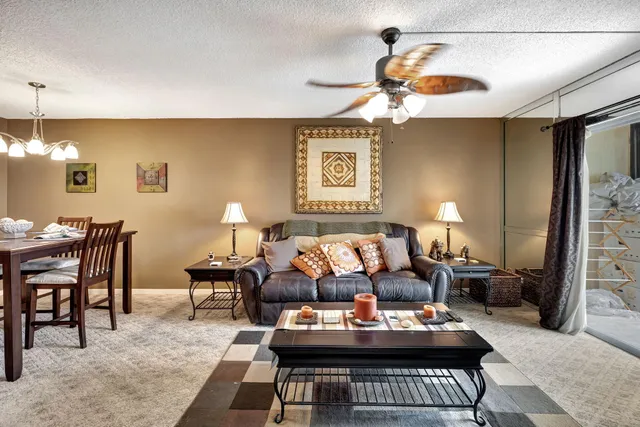 a living room with furniture and a chandelier