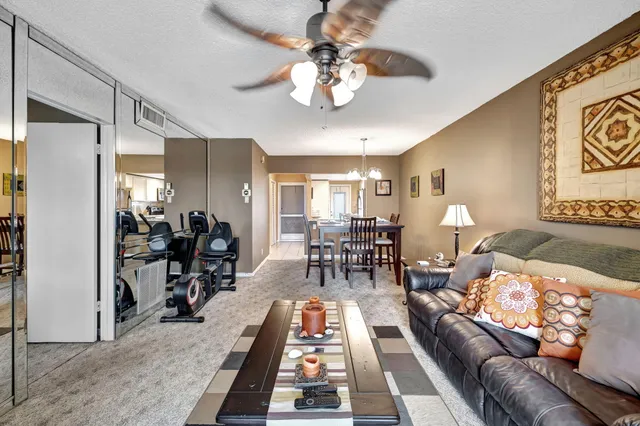 a living room with furniture and a chandelier