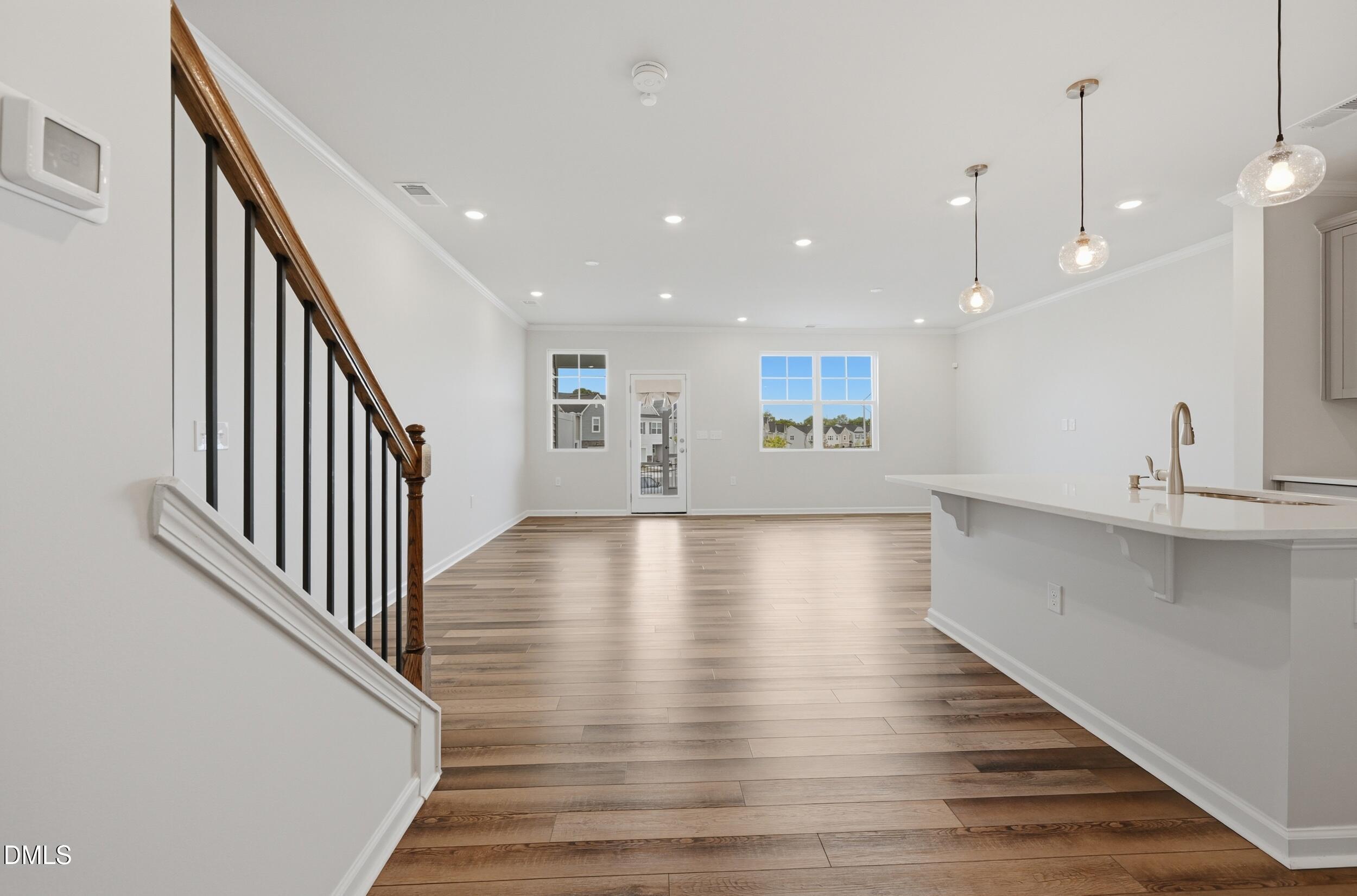 5011 Kota Street Raleigh, NC 27610 - Photo 4 of 42 a view of a kitchen with wooden floor and a staircase